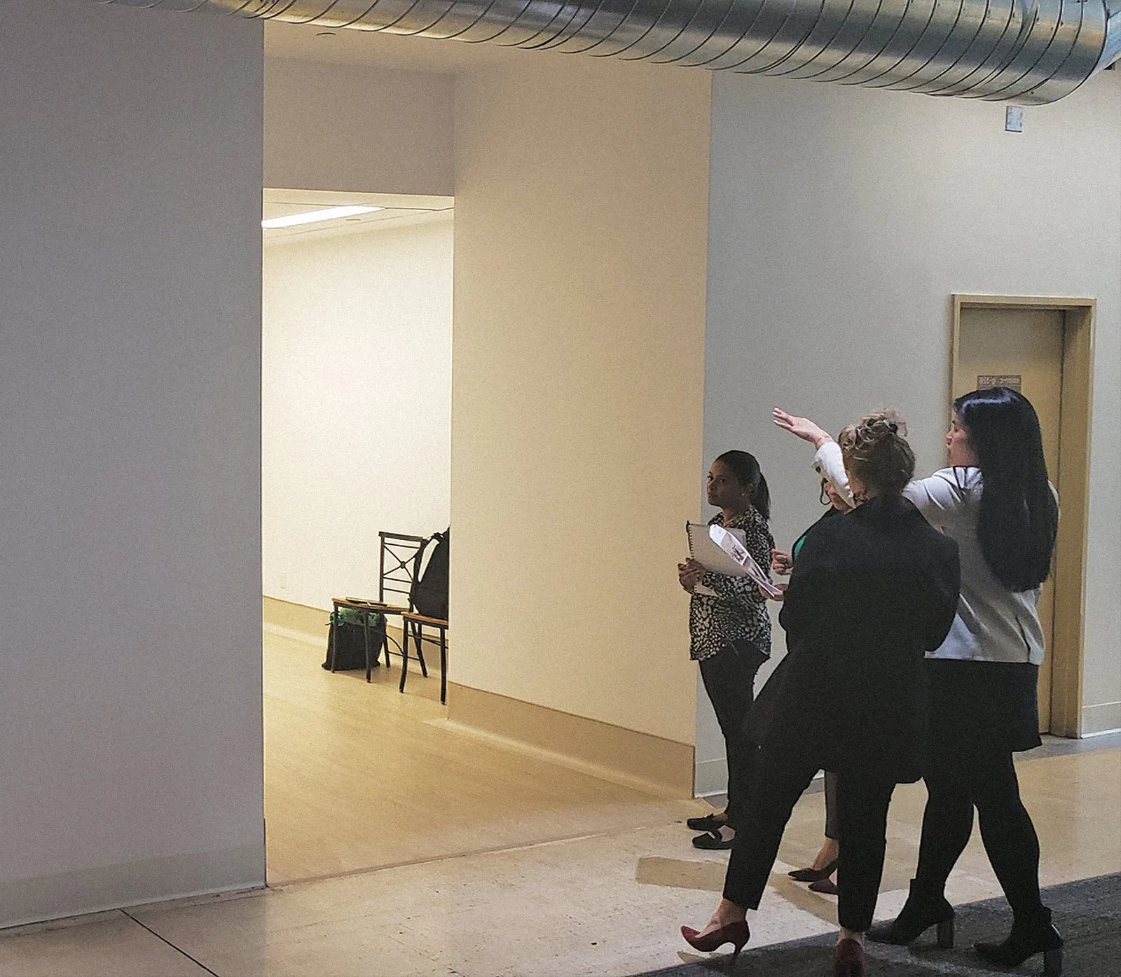 Envision team surveying an empty space during a discovery site visit